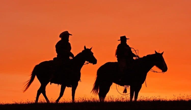 Silhouettes of cowboys on horseback at sunset, Source: Photodune.net