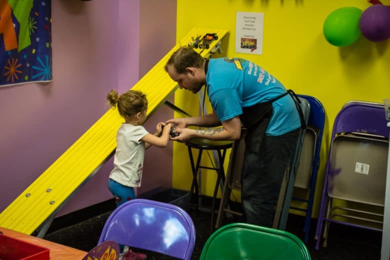 Bricks & Minifigs Reno, Nevada: Staff member helping my daughter with her LEGO slot car Bricks & Minifigs Reno, Nevada: Staff member helping my daughter with her LEGO slot car, 2017 Copyright Will Hull, Windy Pinwheel