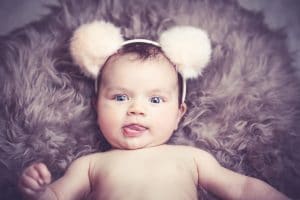 Baby in a headband with puffy balls on top, Source: Clara Morton, Sleeping Angels Co